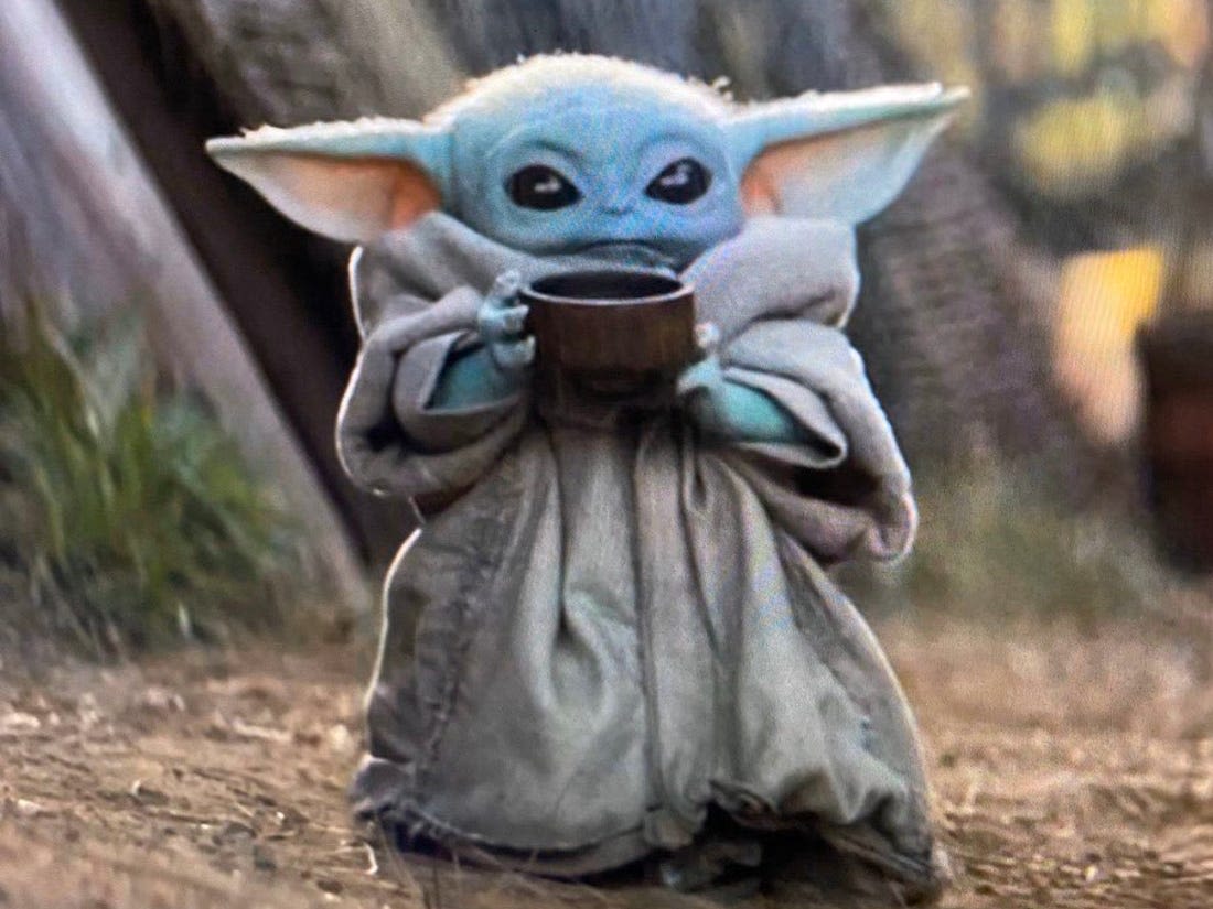 Baby Yoda holding a mug